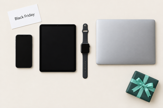 An iPhone, iPad, Apple Watch and laptop arranged beside a wrapped gift box, representing refurbished tech bought during Black Friday