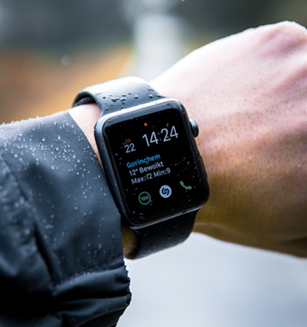 A smartwatch worn on a wrist outdoors
