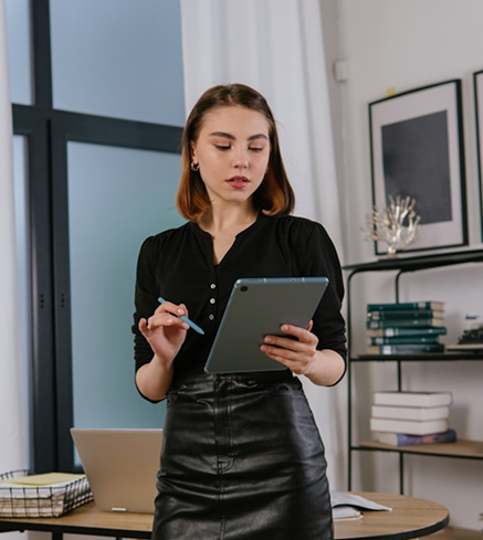 A person using a tablet and stylus at a desk